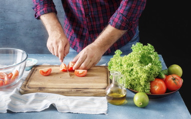 Man cooking salad In the home kitchen