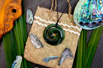 Poster New Zealand - Maori themed objects - jade pendant with wooden mere on woven kite flax bag © CreativeFire