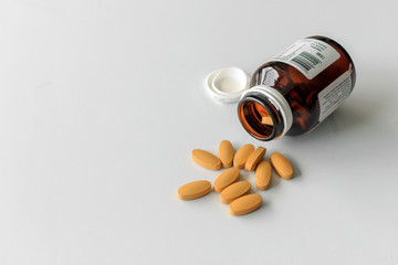 closeup vitamin C tablets on white table with soft-focus and over light background
