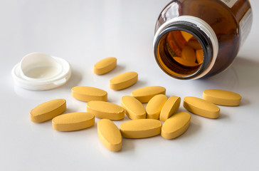 closeup vitamin C tablets on white table with soft-focus and over light in the background