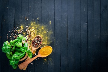 Various spices spoons on stone table. On a wooden board. Top view. Free space for your text.