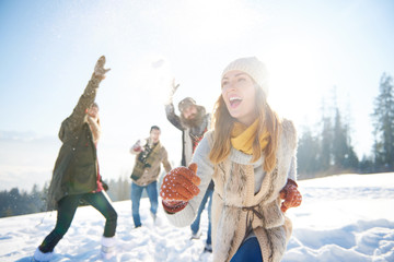 Woman running away from the snow fight