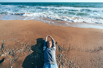 Relaxing on sand by the sea wave, fall beach concept.