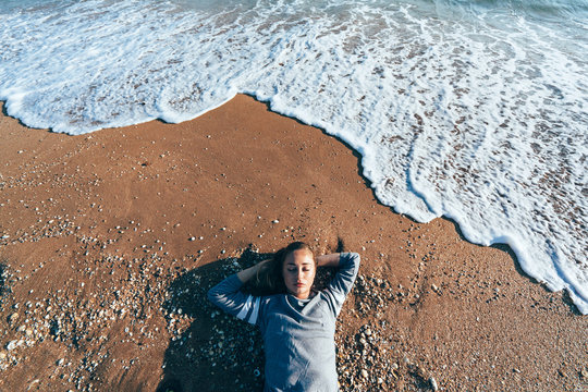 Relaxing on sand by the sea wave, fall beach concept.