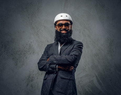 Bearded Islamic male with crossed arms.