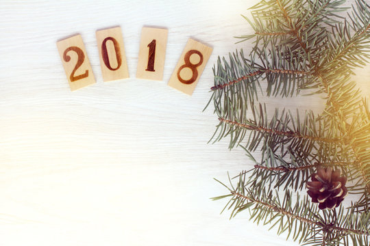 winter holidays 2018/ Flat lay with green twigs Christmas trees and wooden signs with numbers