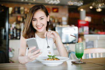 Young Asia woman eating spaghetti at restaurant