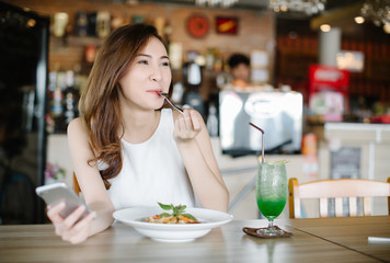 Young Asia woman eating spaghetti at restaurant