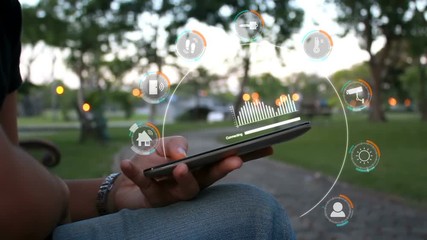 Hands of woman using smartphone select focus on hands shallow depth of field with user interface for smart home security concept on nature evening atmosphere - Powered by Adobe