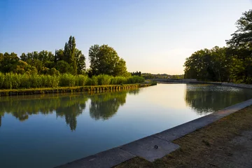 Wall murals Channel The Canal du Midi in Beziers at sunset, a long canal that connects the Atlantic Ocean with the Mediterranean Sea in Southern France. A world heritage site since 1996