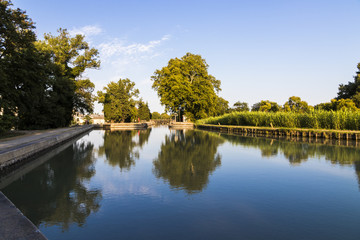 The Canal du Midi in Beziers at sunset, a long canal that connects the Atlantic Ocean with the Mediterranean Sea in Southern France. A world heritage site since 1996