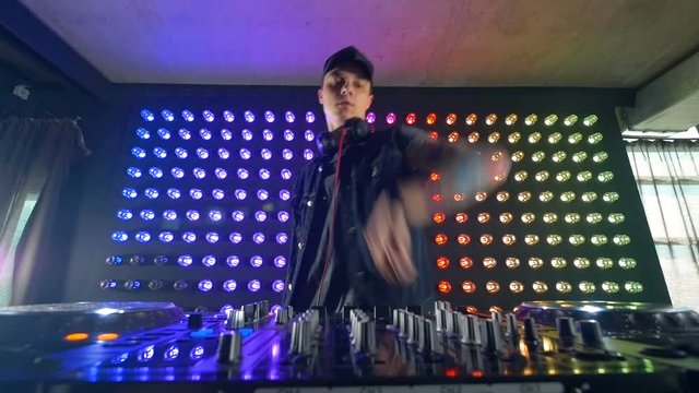 DJs fingers turning small mixer knobs.