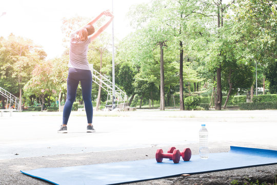 Young female stretching before exercising at the park, Healthy lifestyle concept