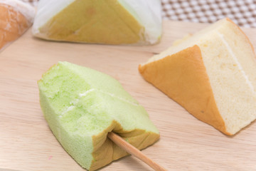 orange and pandan  Chiffon cake on wooden plate