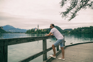 Tourist man enjoying the view on the lake.