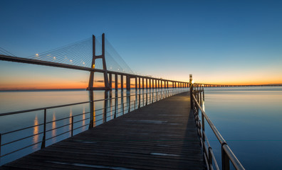 Obraz premium Sunrise in Lisbon, under the Vasco da Gama Bridge, portugal