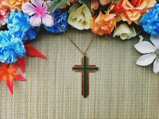 Christian Cross with various colorful flowers decoration