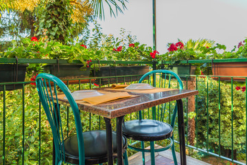 romantic restaurant table and geraniums