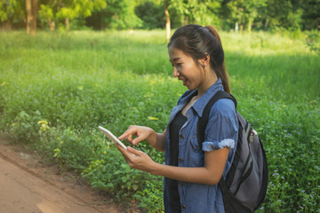 Asian female traveler and tablet