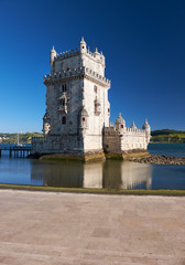 Fototapeta premium Belem Tower on river Tagus in Lisbon with reflection in water on blue sky background, Portugal