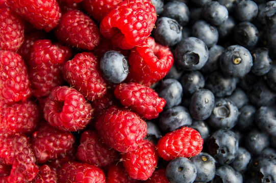 Close-up on composition of raspberry and blueberry fruits
