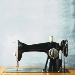 Old vintage sewing machine on a gray background