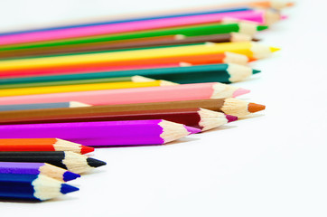 Colored pencils on white background. Close-up.