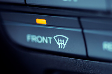 Close-up to the front window heater icon in a modern car