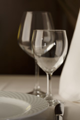 Meal setting arranged in elegant way, Wineglasses and silverware, Selective focus with soft light