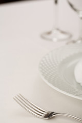 Fork and plate arranged in elegant setting, Selective focus with soft light