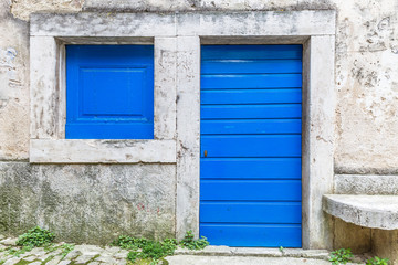 Blue entrance door to a house on stone street in Istria, Croatia, Europe.