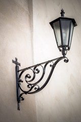 An ancient metal street lamp on the facade of the house in Istria, Croatia, Europe.