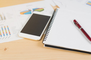 Workplace. Phone, tablet and notepad on the table
