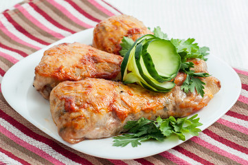 chicken fried legs with vegetables on the plate