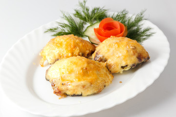 Meat cutlet steak under cheese with greens