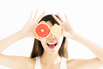 happy Woman showing lemon with grapefruit.
