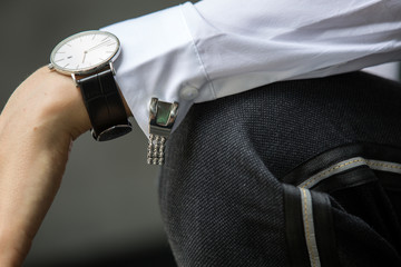 Image of woman hand at business suit wearing white shirt with cufflinks and watch resting her hand