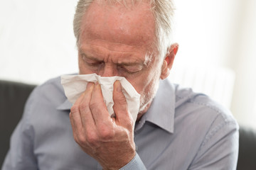 Man blowing his nose