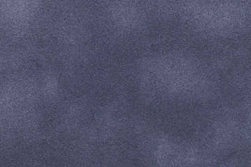 Background of dark gray and blue suede fabric closeup. Velvet matt texture of nubuck textile
