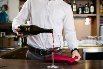 Sommelier pouring wine into the wineglass
