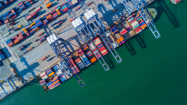 Aerial view of a Cargo vessel operations on harbor, shot from drone,Thailand.
