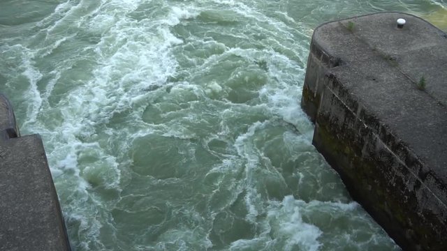 Levee elongated naturally occurring ridge or artificially constructed fill or wall, which regulates water levels. Water has small waves. Concept of contraction for save life water level.