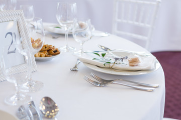table setting with spoon, knife, plates and glass