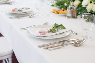 table setting with spoon, knife, plates and glass