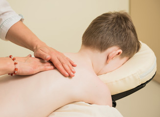 Obraz na płótnie Canvas therapist making massage on boy back