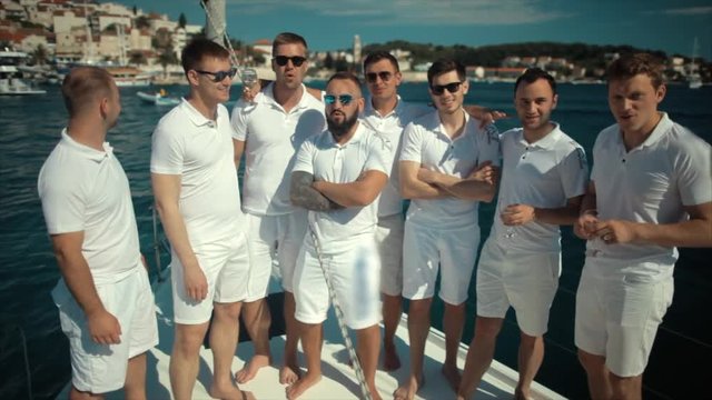 Sailing crew posing for a group portrait on board