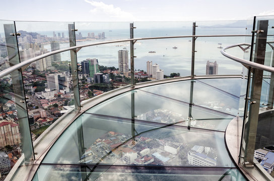  Skywalk with transparent glass floor at the 66th floor and aerial view of Penang island from the Komtar Tower, Penang, Malaysia