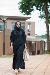 Arabian woman walking on the street.