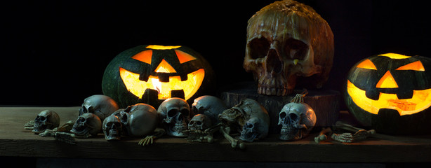 Pumpkin have a candle light and Skull in the dark atmosphere on Halloween night