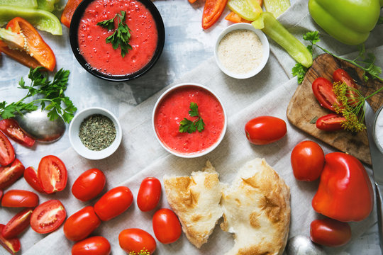Composition of gazpacho and fresh vegetables, bread, serving a family dinner, top view